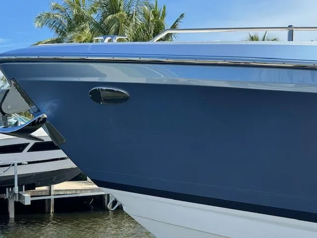 Slide: The Image of 2022 Formula 430 Super Sport Crossover boat docked near palm trees. - 44