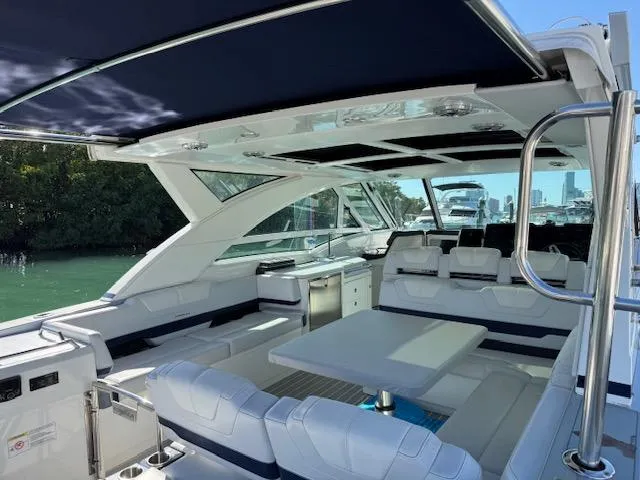 Slide: The Image of 2022 Formula 430 Super Sport Crossover luxury yacht interior with seating and table. - 8