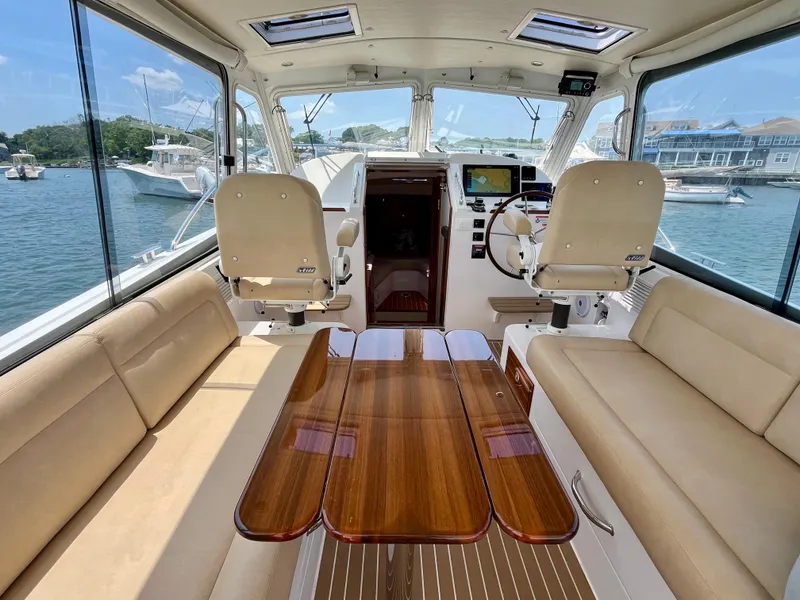 Slide: The Image of Interior of a 2019 MJM 35z boat with luxurious seating and wooden table. - 3