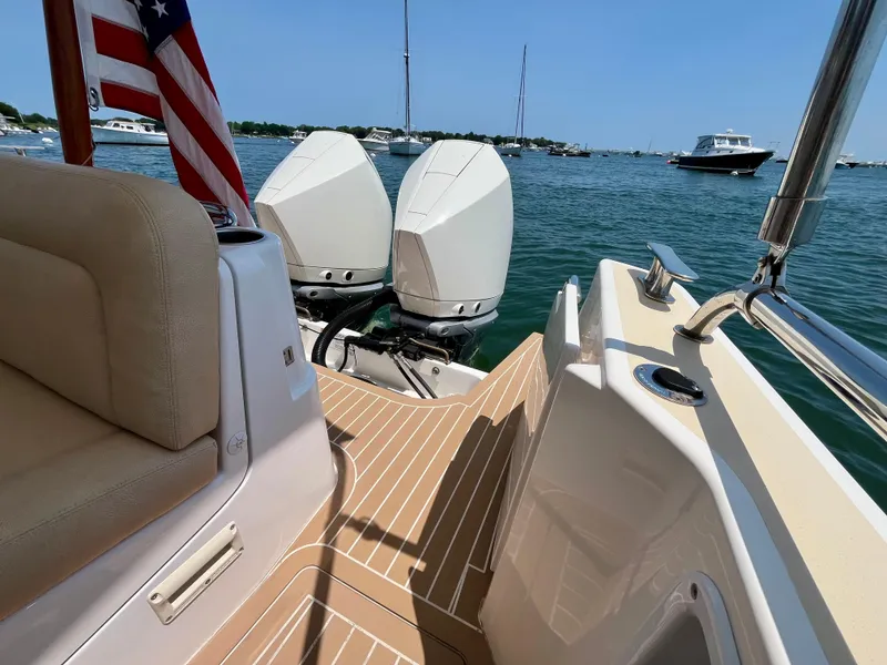 Slide: The Image of 2019 MJM 35z boat with dual engines, docked on a sunny day, featuring a spacious deck. - 42