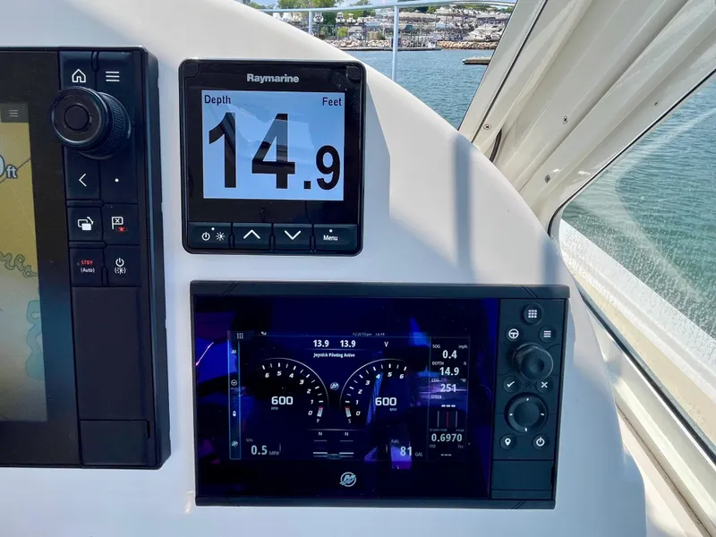 Slide: The Image of MJM 35z 2019 boat dashboard with Raymarine depth display showing 14.9 feet. - 35