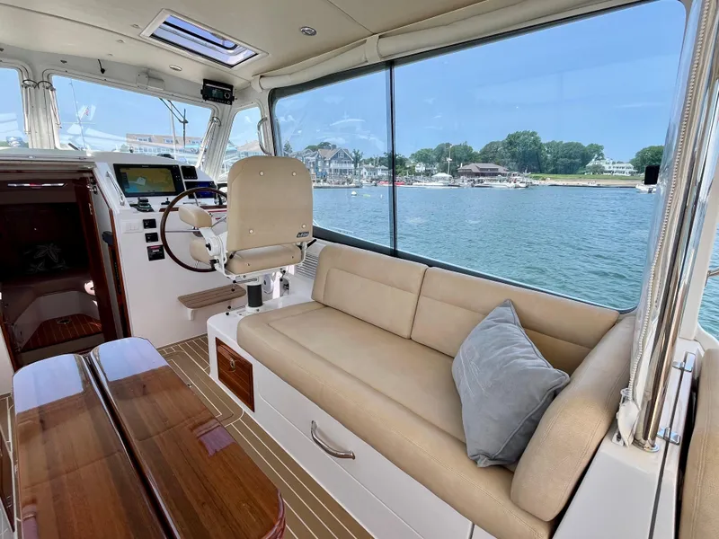 Slide: The Image of Interior of 2019 MJM 35z yacht with seating, table, and waterfront view. - 19