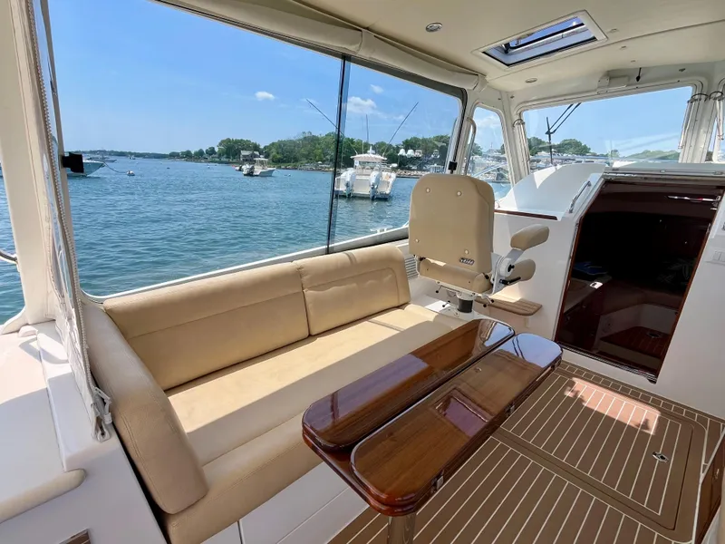 Slide: The Image of Interior of 2019 MJM 35z yacht with seating and table, overlooking a scenic waterfront. - 18