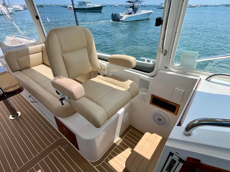 Slide: The Image of Interior of 2019 MJM 35z boat with beige seating and ocean view. - 44