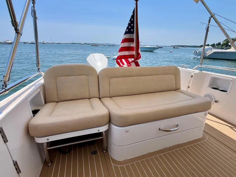 Slide: The Image of 2019 MJM 35z boat with beige seating, American flag, and ocean view. - 14