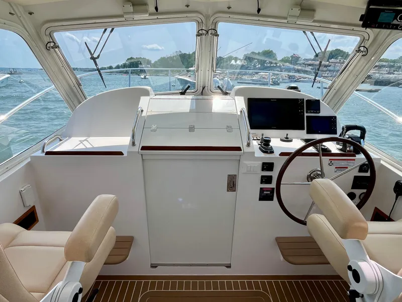 Slide: The Image of Interior view of 2019 MJM 35z boat cockpit with dual seats and navigation controls. - 25