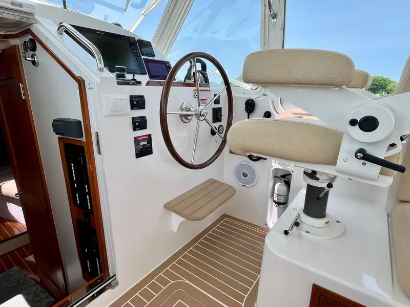 Slide: The Image of Helm of 2019 MJM 35z boat with steering wheel and navigation controls. - 29