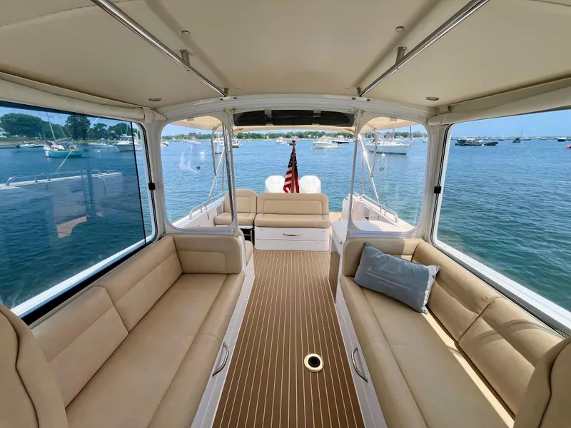 Slide: The Image of Luxurious 2019 MJM 35z boat interior with beige seating, overlooking serene waters. - 47