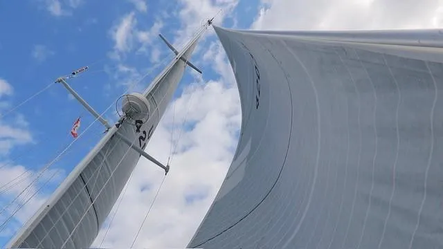 Slide: The Image of Sailing view of 1987 Hinckley Sou'wester 42 with sails against a blue sky. - 11