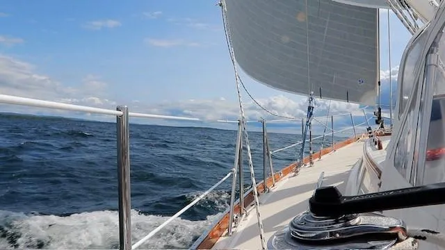 Slide: The Image of Sailing on a 1987 Hinckley Sou'wester 42 yacht in open waters under clear skies. - 4