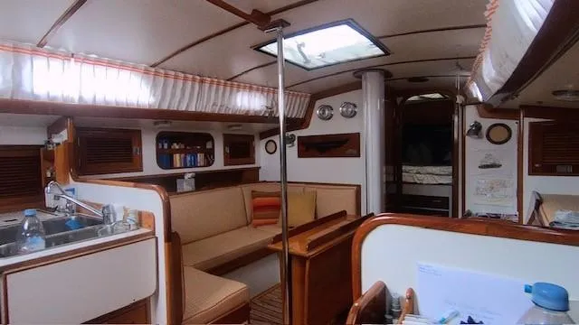 Slide: The Image of Interior of 1987 Hinckley Sou'wester 42 sailboat, featuring cozy seating and nautical decor. - 7