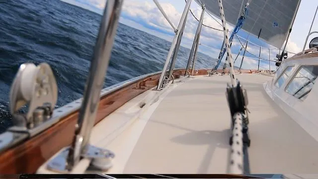 Slide: The Image of 1987 Hinckley Sou'wester 42 sailboat on open water, showcasing deck and rigging. - 8