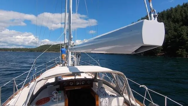 Slide: The Image of Sailing on a 1987 Hinckley Sou'wester 42 yacht in clear blue waters. - 9