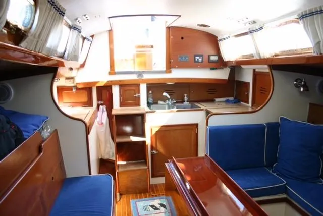Slide: The Image of Interior of a 1967 Hinckley Bermuda 40 sailboat with blue seating and wooden cabinetry. - 12