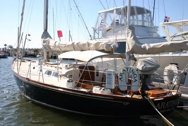 Slide: The Image of 1967 Hinckley Bermuda 40 sailboat docked in a marina, featuring classic design and rigging. - 5