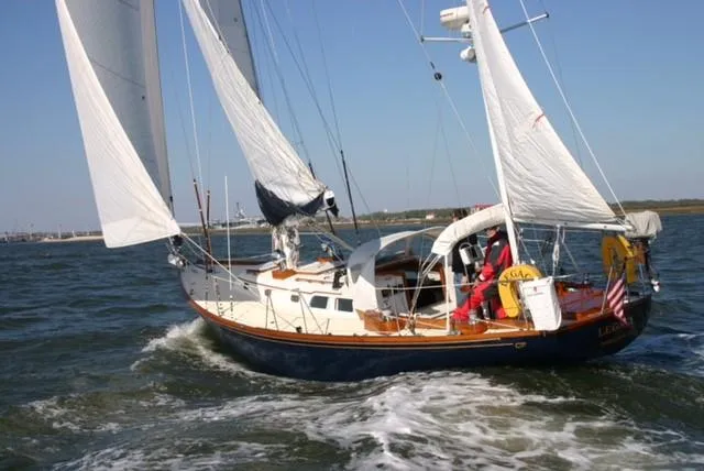 Slide: The Image of 1967 Hinckley Bermuda 40 sailboat navigating open waters with full sails. - 3