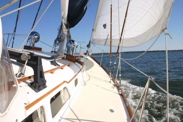 Slide: The Image of Sailing on a 1967 Hinckley Bermuda 40 yacht with white sails and blue sky. - 8