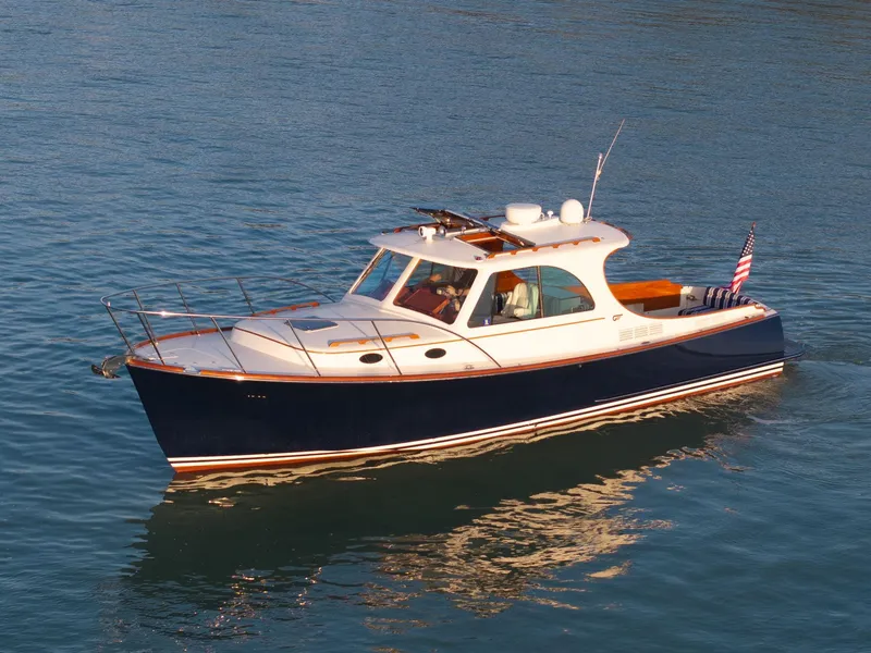 The Image of 2014 Hinckley Picnic Boat 37 MKIII cruising on calm blue water. - 0