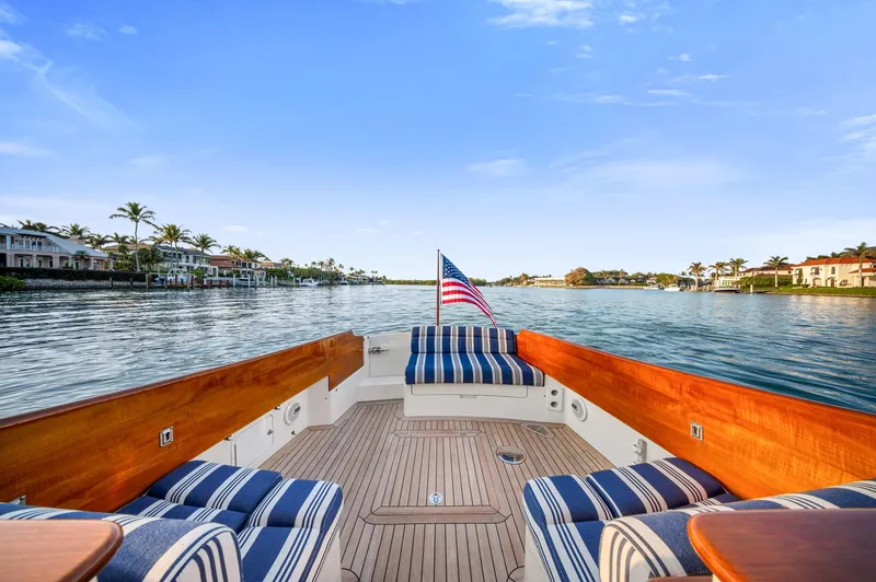 Slide: The Image of Hinckley Picnic Boat 37 MKIII, 2014, with striped seating, cruising on a scenic waterway. - 11