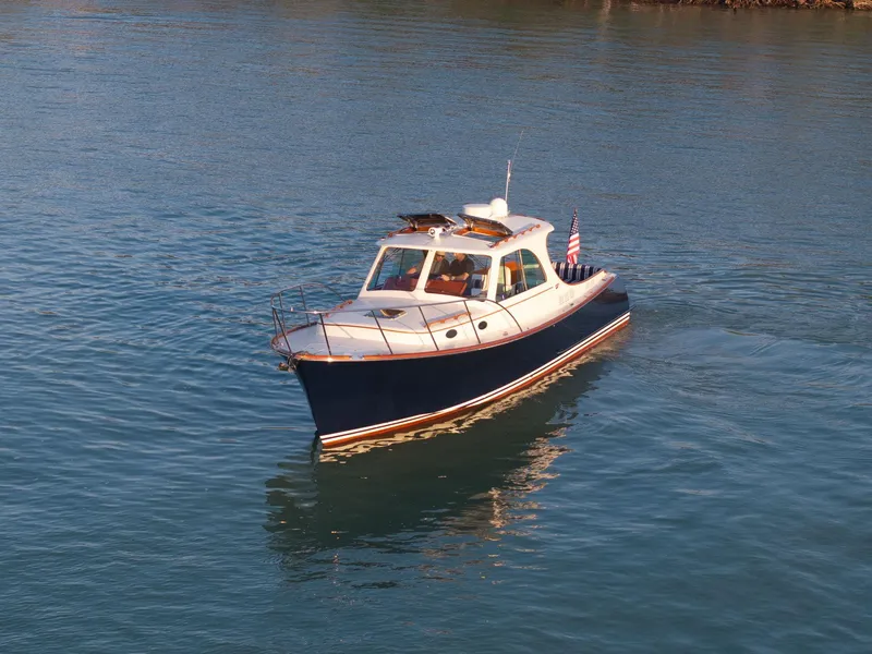 Slide: The Image of 2014 Hinckley Picnic Boat 37 MKIII cruising on calm water. - 13