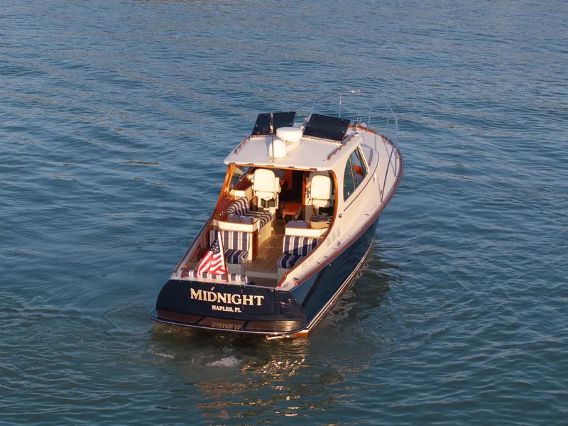 Slide: The Image of 2014 Hinckley Picnic Boat 37 MKIII cruising on calm waters. - 2
