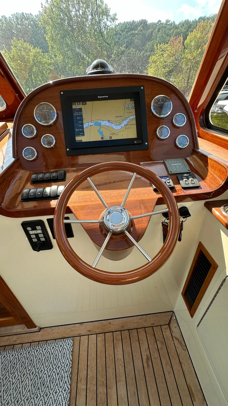 Slide: The Image of Helm of 2009 Hinckley Picnic Boat 37 MKIII with navigation display and wooden steering wheel. - 4