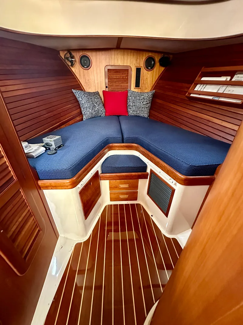 Slide: The Image of 2009 Hinckley Picnic Boat 37 MKIII cabin with wooden interior and blue bedding. - 7