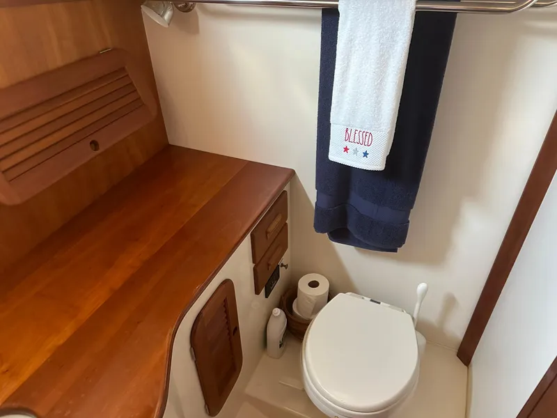 Slide: The Image of Hinckley Picnic Boat 37 MKIII 2009 bathroom with wooden accents and towel rack. - 9