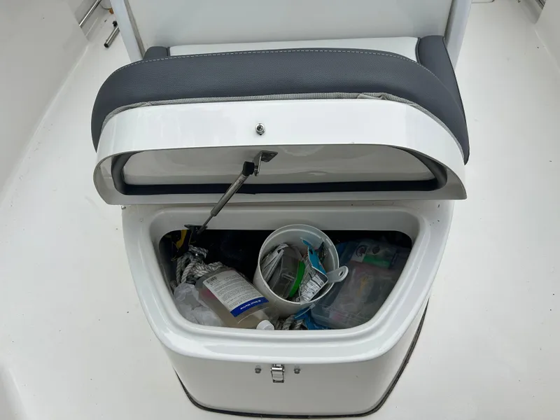 Slide: The Image of Storage compartment on a 2020 Tidewater 272 CC Adventure boat, containing various items. - 10