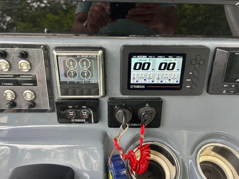 Slide: The Image of Control panel of 2020 Tidewater 272 CC Adventure boat with Yamaha displays and switches. - 14