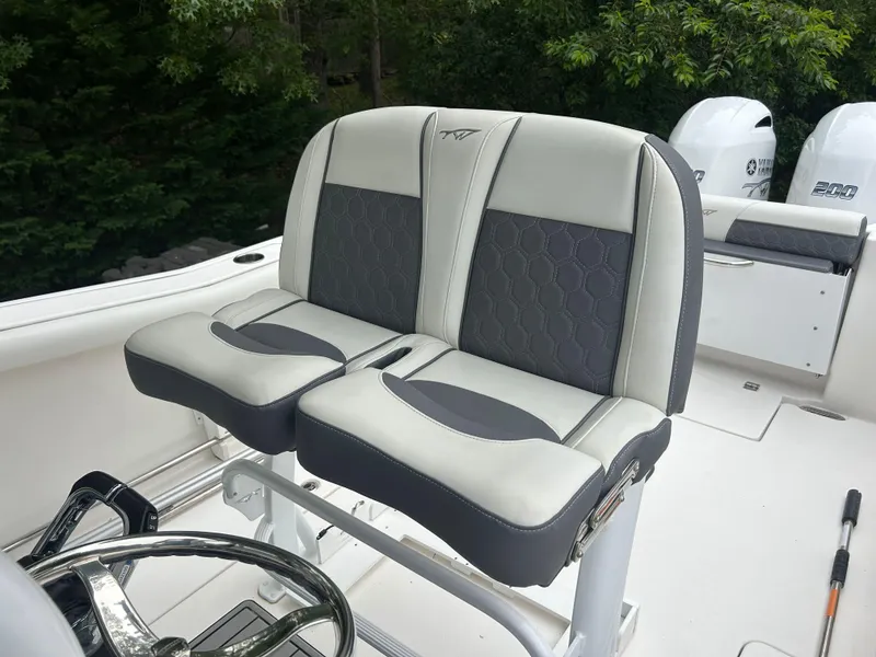 Slide: The Image of 2020 Tidewater 272 CC Adventure boat seats with dual outboard motors in background. - 18