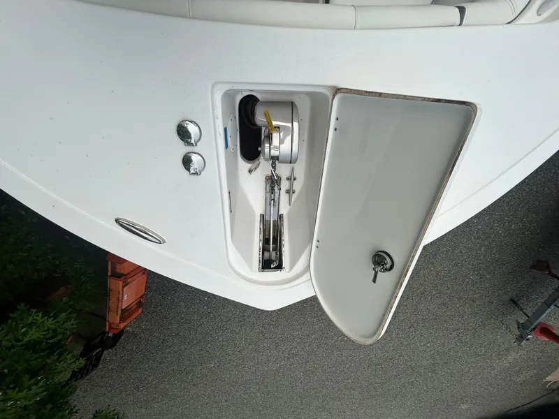Slide: The Image of 2020 Tidewater 272 CC Adventure boat anchor compartment with open hatch. - 23