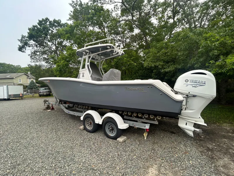 Slide: The Image of 2020 Tidewater 272 CC Adventure boat on trailer, parked outdoors. - 29