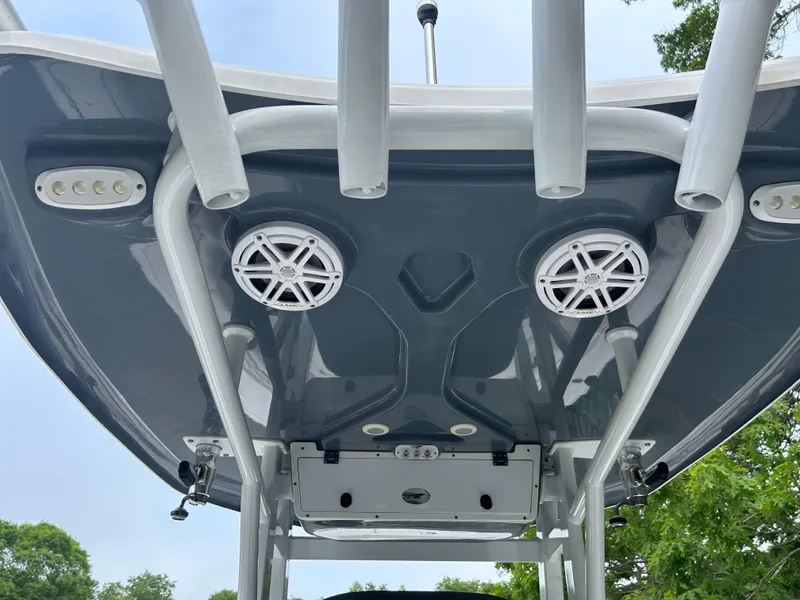 Slide: The Image of 2020 Tidewater 272 CC Adventure boat's T-top with speakers and rod holders. - 3
