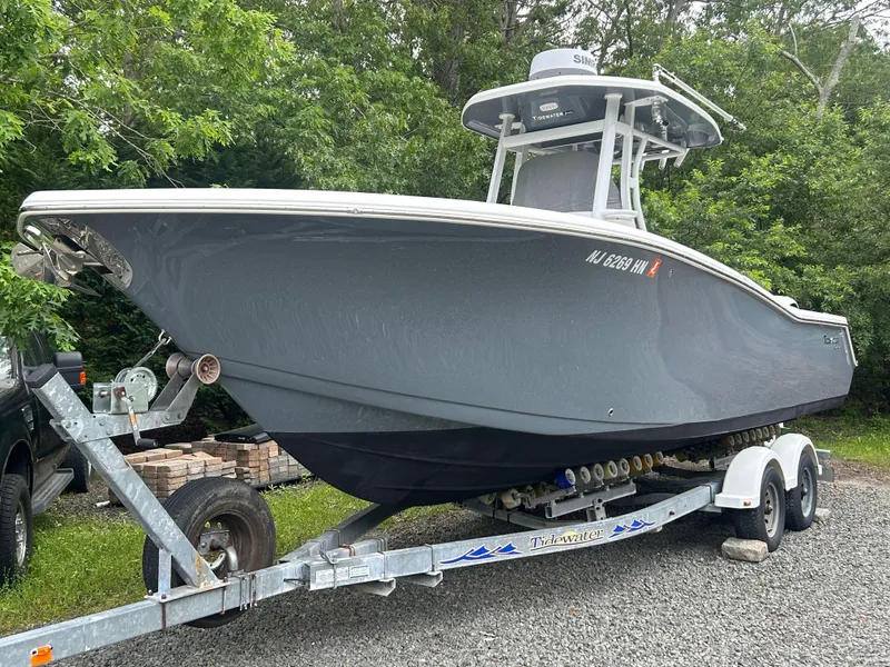 Slide: The Image of 2020 Tidewater 272 CC Adventure boat on trailer, parked outdoors. - 31