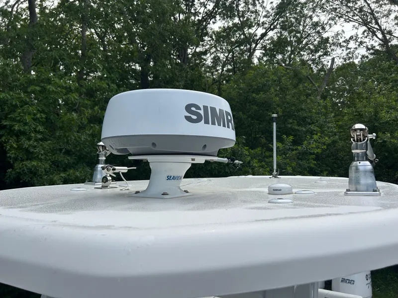 Slide: The Image of Radar equipment on 2020 Tidewater 272 CC Adventure boat against a forest backdrop. - 6