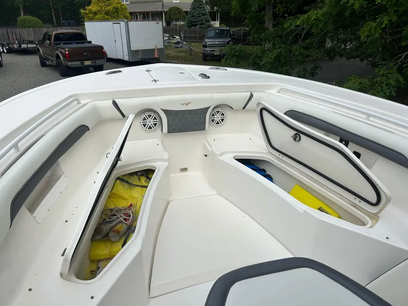 Slide: The Image of 2020 Tidewater 272 CC Adventure boat with open storage compartments and speakers on deck. - 8