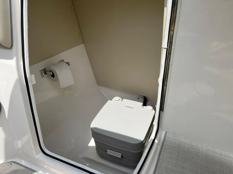 Slide: The Image of 2022 Regal FasDeck boat interior with beige seating and speaker detail. - 10