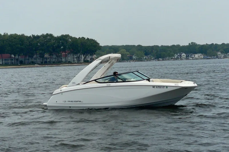 Slide: The Image of 2022 Regal Fasdeck boat interior with portable toilet and toilet paper holder. - 4