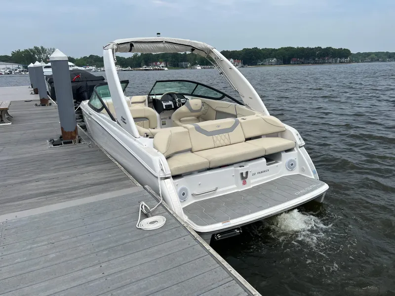 Slide: The Image of 2022 Regal FasDeck boat on calm water, showcasing sleek design and modern features. - 5
