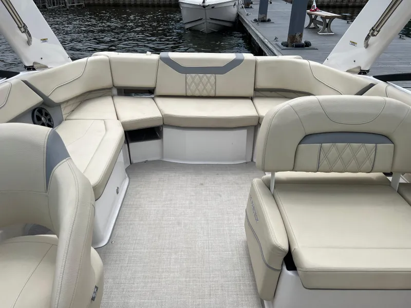 Slide: The Image of 2022 Regal FasDeck boat docked on a lake with spacious seating. - 8