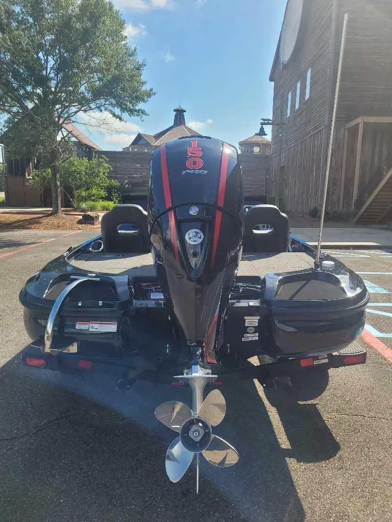 Slide: The Image of 2025 Nitro Z18 Pro boat with powerful outboard motor, parked outdoors. - 1