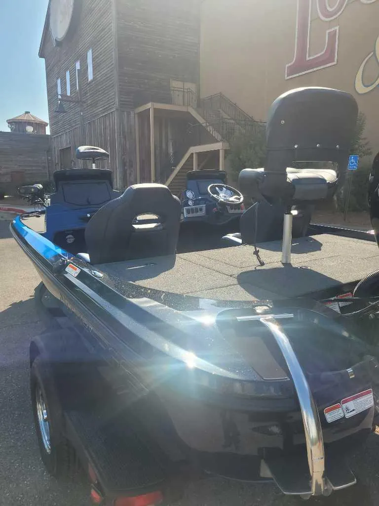 Slide: The Image of 2025 Nitro Z18 Pro boat with seating, parked outdoors in sunlight. - 2