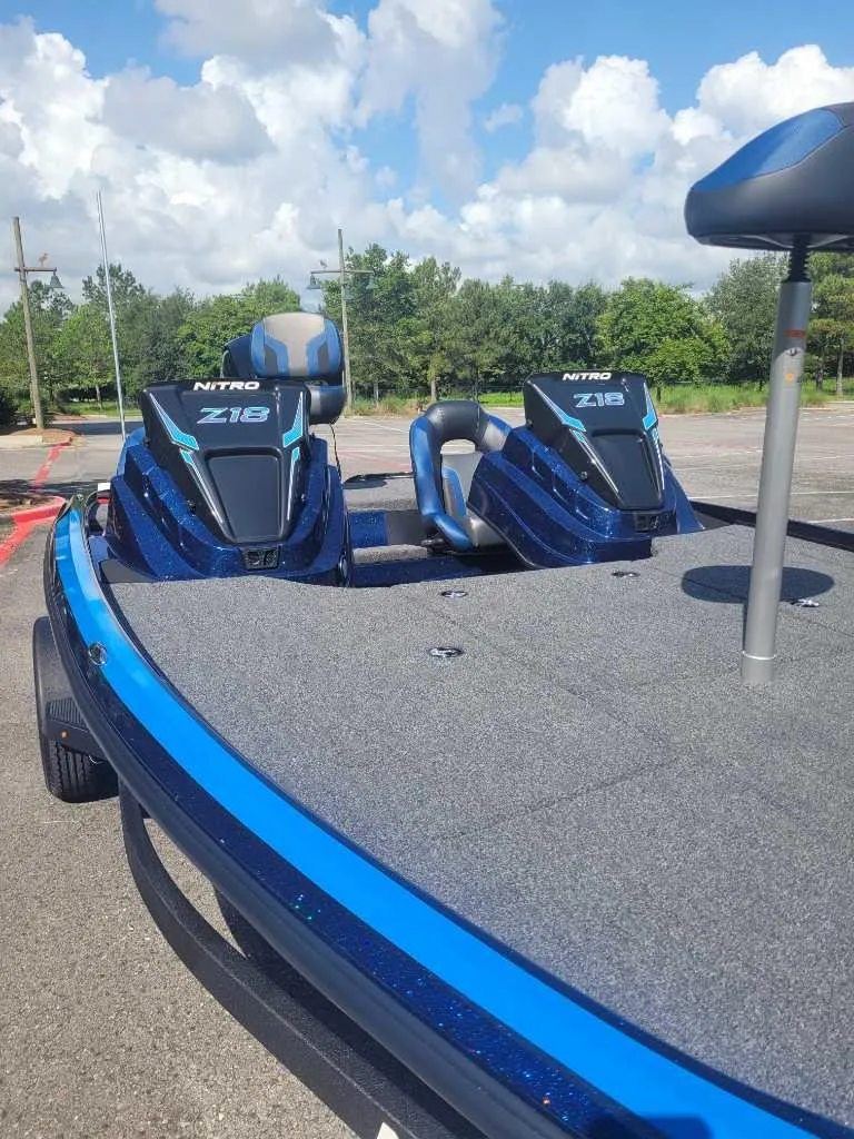 Slide: The Image of 2025 Nitro Z18 Pro boat with dual seats, blue finish, parked outdoors. - 4