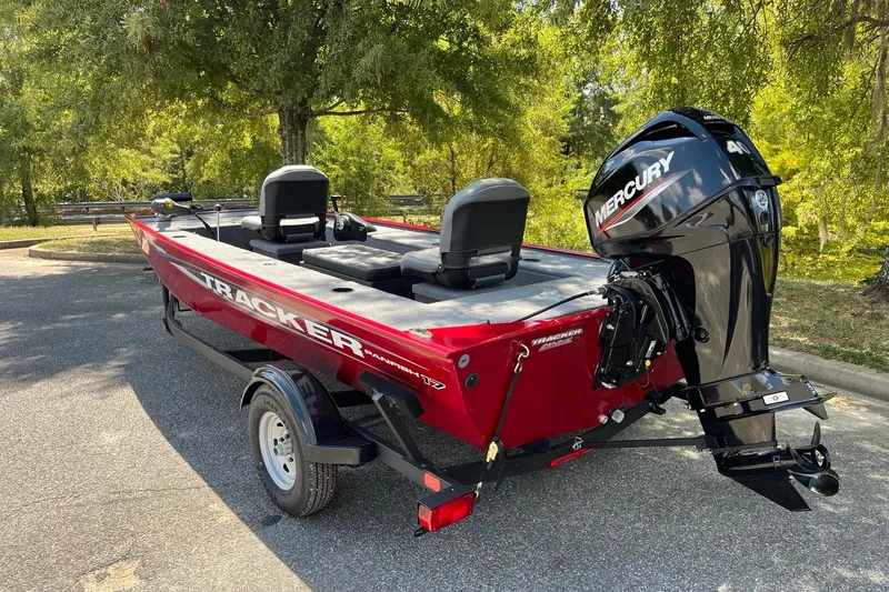 Slide: The Image of 2025 Tracker Panfish 17 boat with Mercury engine, parked outdoors. - 4
