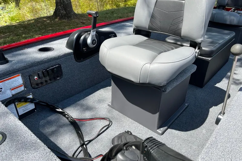 Slide: The Image of 2025 Tracker Panfish 17 boat interior with gray seating and control panel. - 9