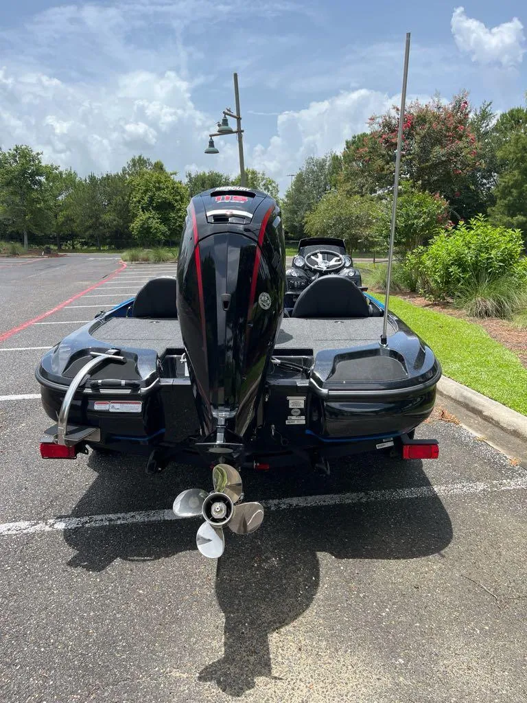 Slide: The Image of 2025 Nitro Z17 boat with powerful outboard motor in a parking lot. - 2