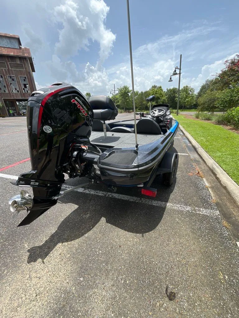 Slide: The Image of 2025 Nitro Z17 boat with powerful outboard motor in a parking lot. - 3