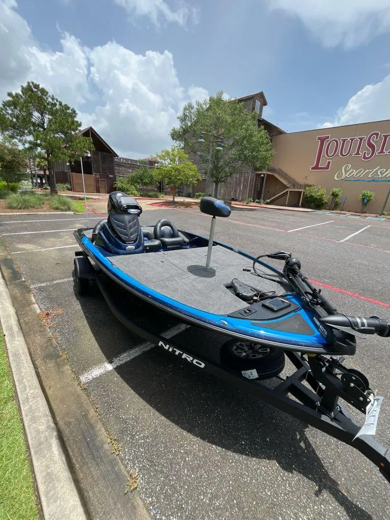 Slide: The Image of 2025 Nitro Z17 boat parked outdoors near a rustic building under a cloudy sky. - 5