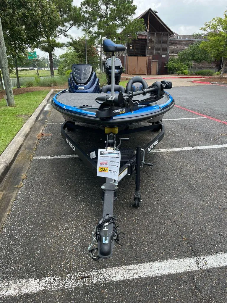 Slide: The Image of 2025 Nitro Z17 boat parked, featuring a blue exterior and trailer in a lot. - 6